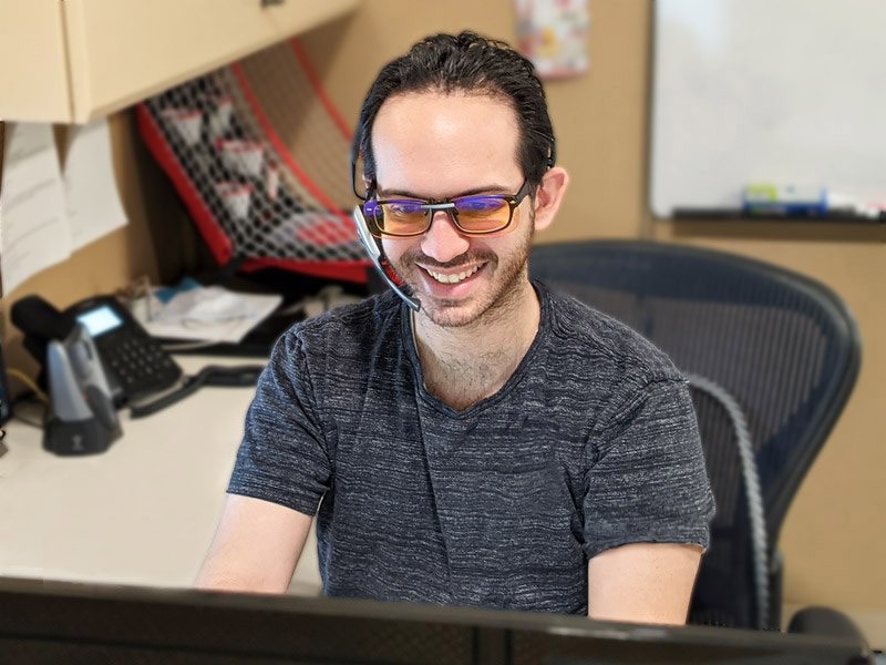 Customer service representative working on computer with headset