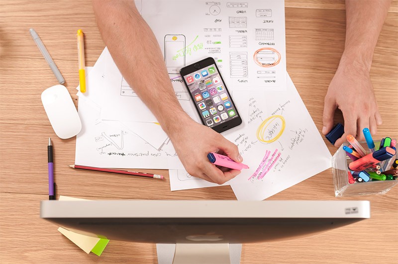 Man working at desk with scattered papers